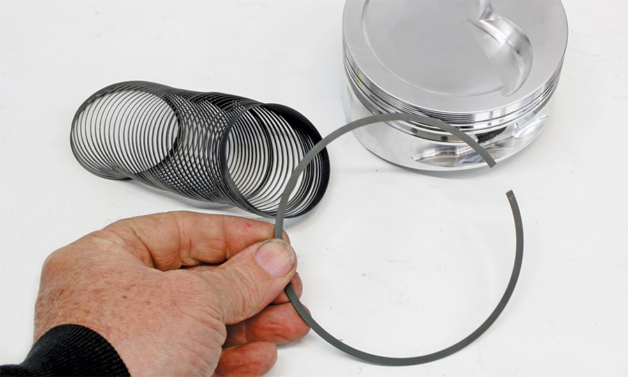 Piston ring being displayed with hand in view