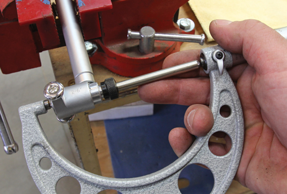 mechanic zero's the dial bore gauge using the proper arrangement of anvils