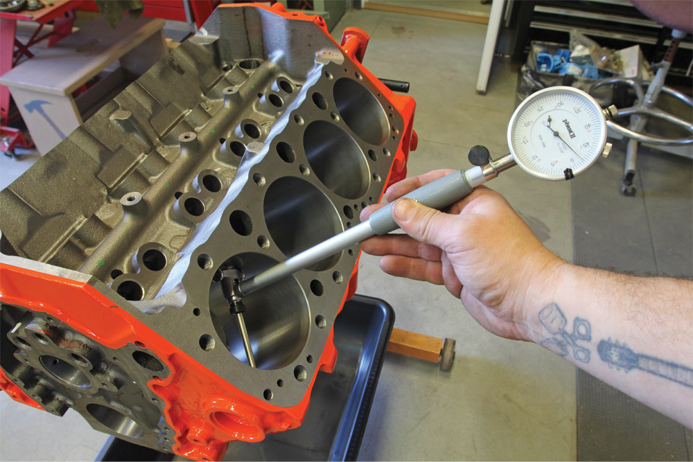 mechanic measures the diameter of the engine bore