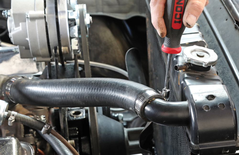 view of newly installed OEM-style molded radiator hoses and new stainless steel clamp