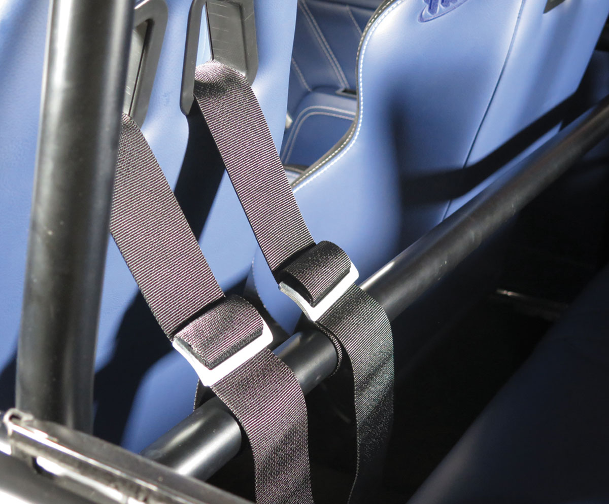 view of shoulder straps attached to harness behind front seats