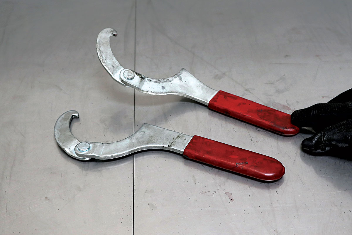 Slightly bent spanner wrench for easier spring adjustment