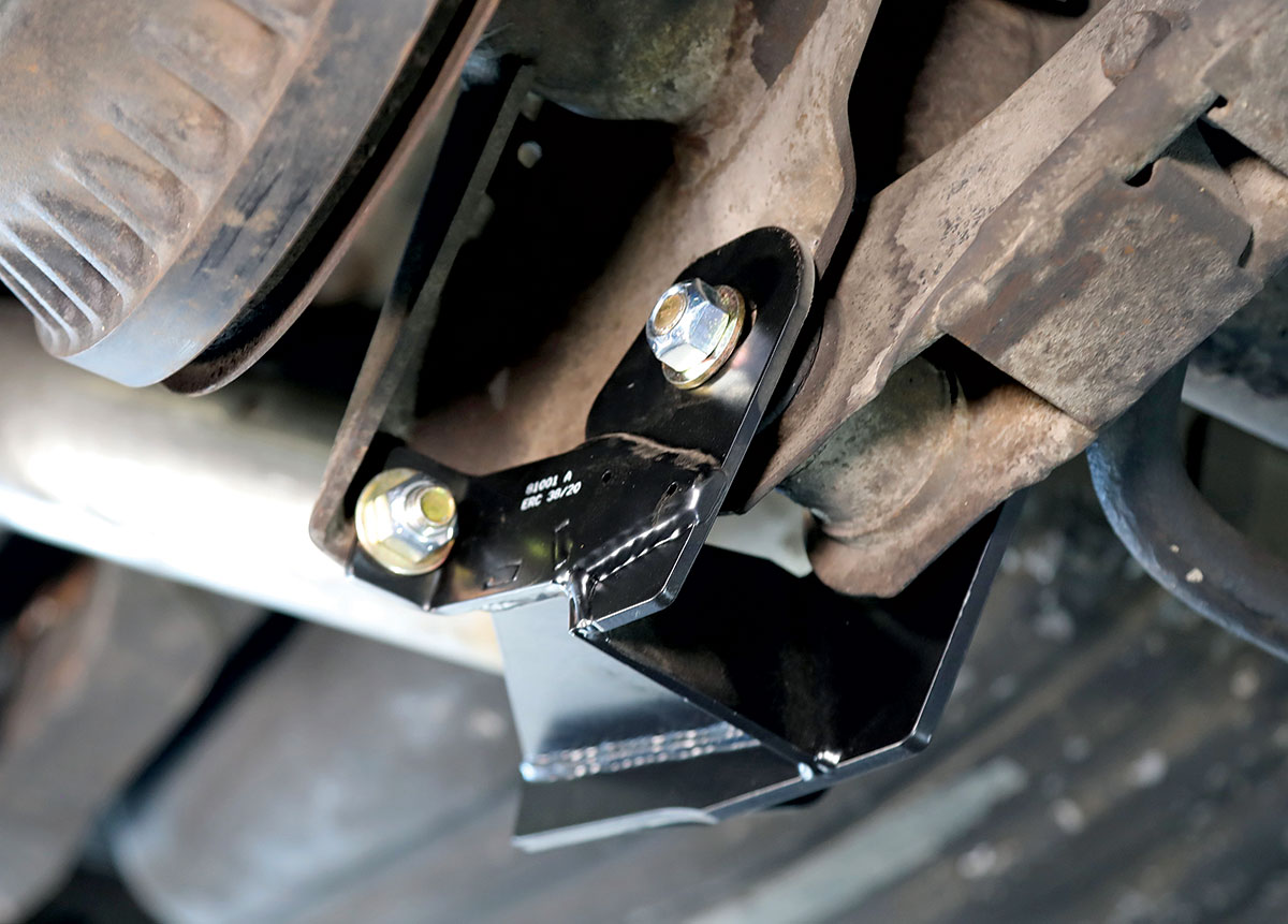 Lower coilover brackets attached to the control arms and shock mounting points