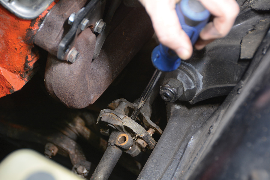 seperating the coupler from the steering shaft with a large screwdriver