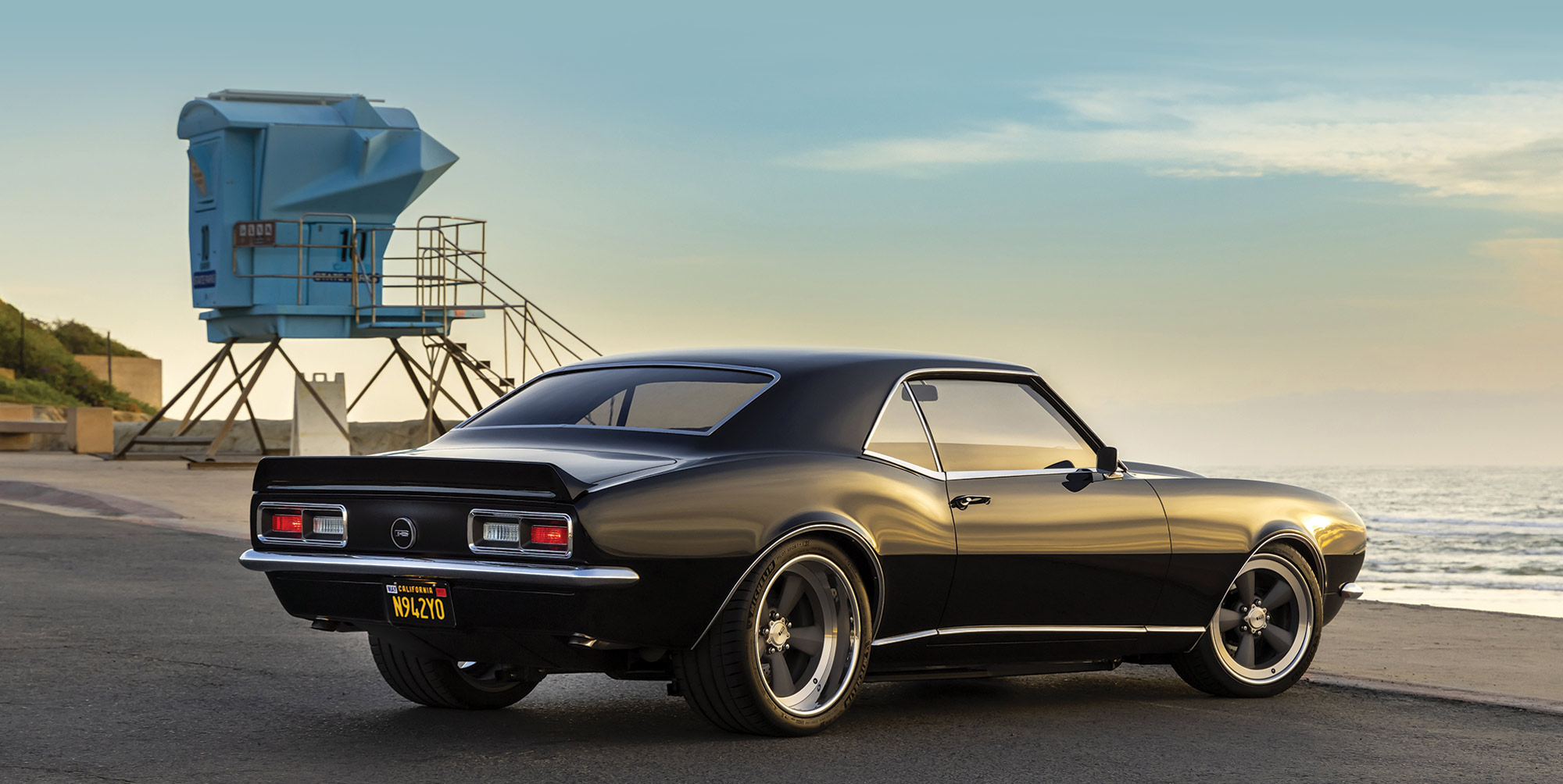 1968 Camaro side profile with beach tower behind it