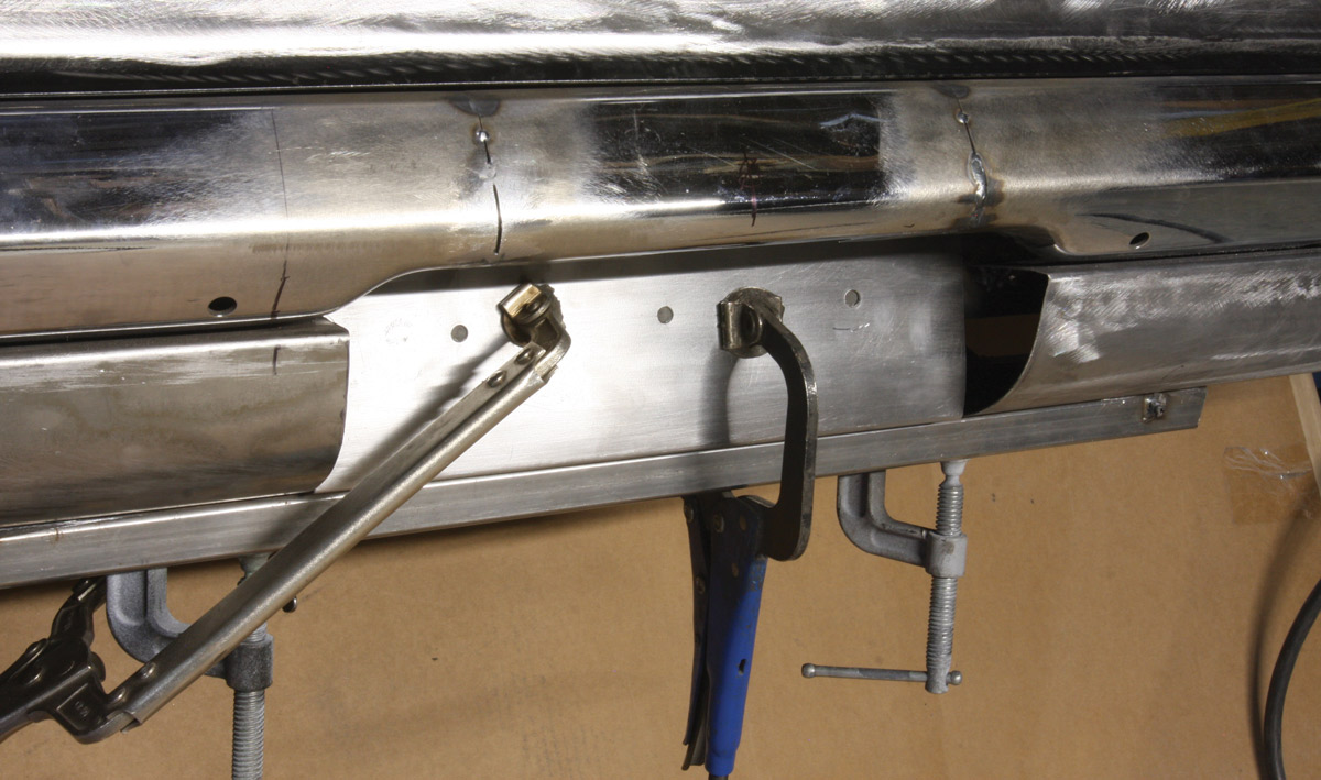 Three holes were drilled in the vertical section to plug weld the panel to the rear body crossmember before it was clamped and then welded in place