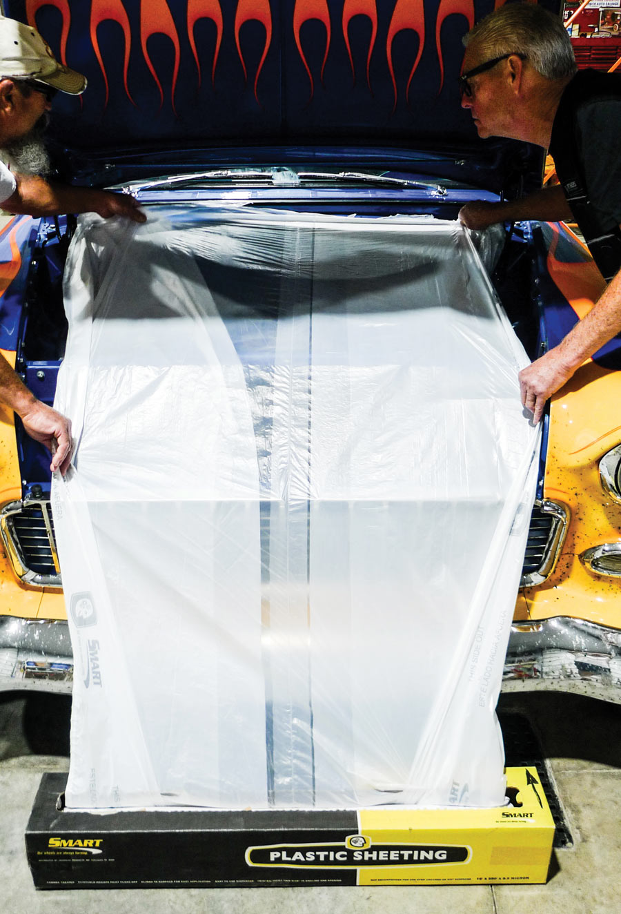 Since there’s no need to wet the engine down we’ll stretch out a section of static-cling plastic sheeting. 