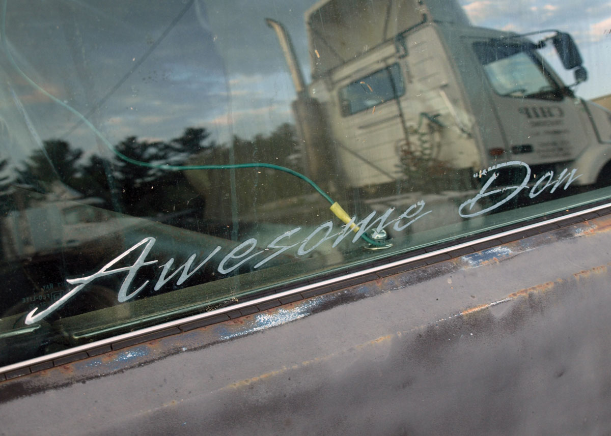 Below the “A” in the “Awesome Don” driver side door window graphics, part of the multi-point rollbar is visible