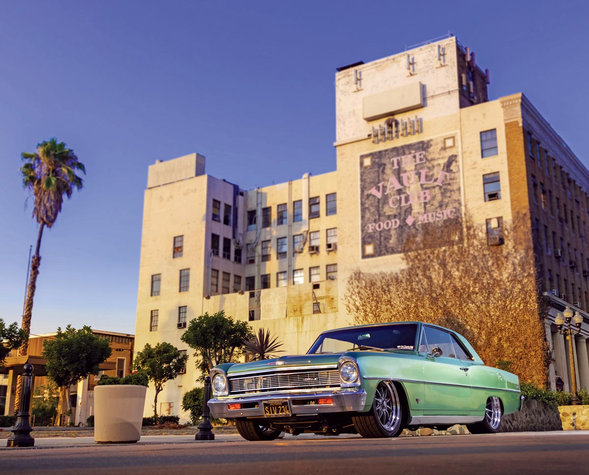 1966 Chevy II Nova in front of a building