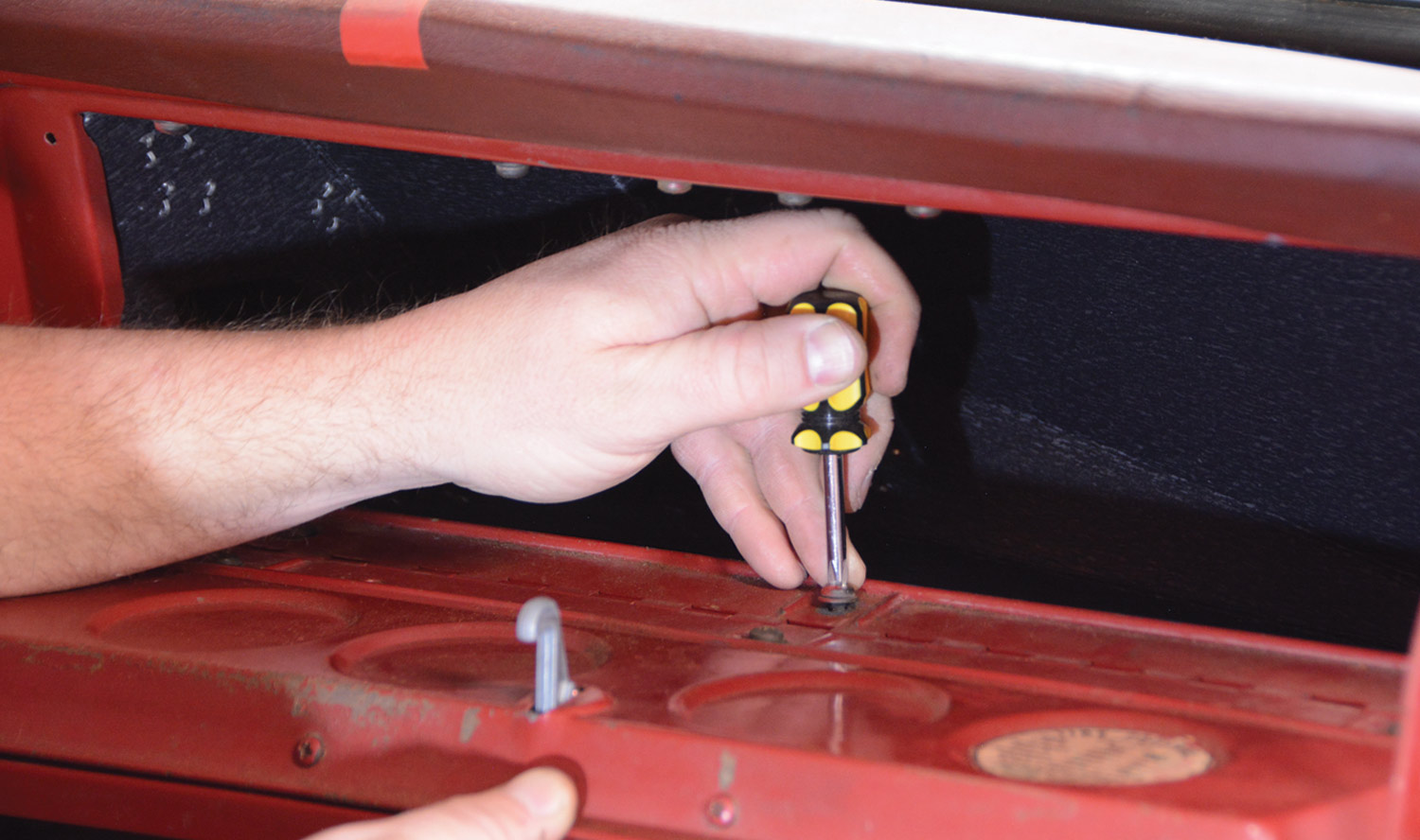 mechanic removes the glovebox door