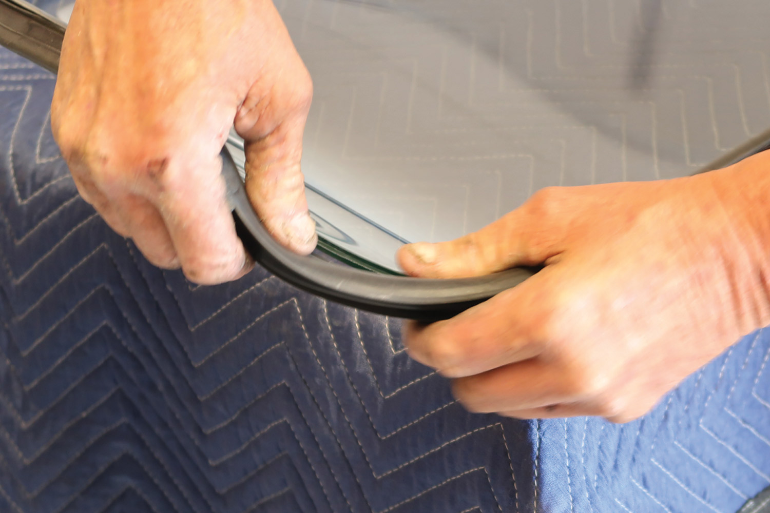 mechanic applies the quality Steele Rubber gasket to the back windshield for a properly contoured fit