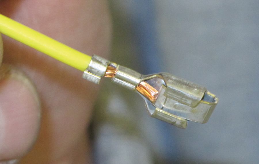 This is a properly executed crimp. Note how one portion of the terminal wraps around the conductor. The second portion captures the insulator, which provides strain release that helps the conductor from being pulled out of the terminal.
