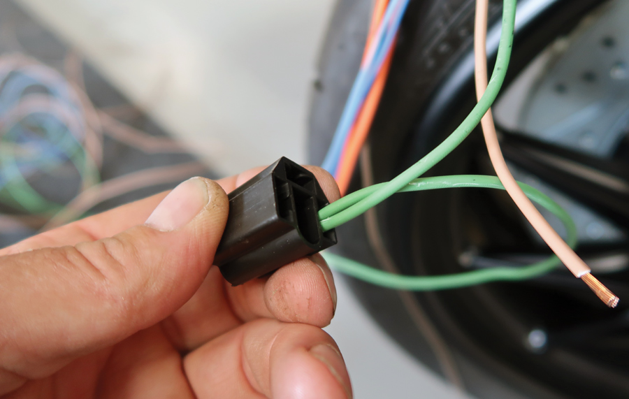 Once the terminal is crimped on the wire it’s inserted into the plastic connector until it locks in place. This is a headlight harness plug; the second wire feeds the headlight on the other side of the car.