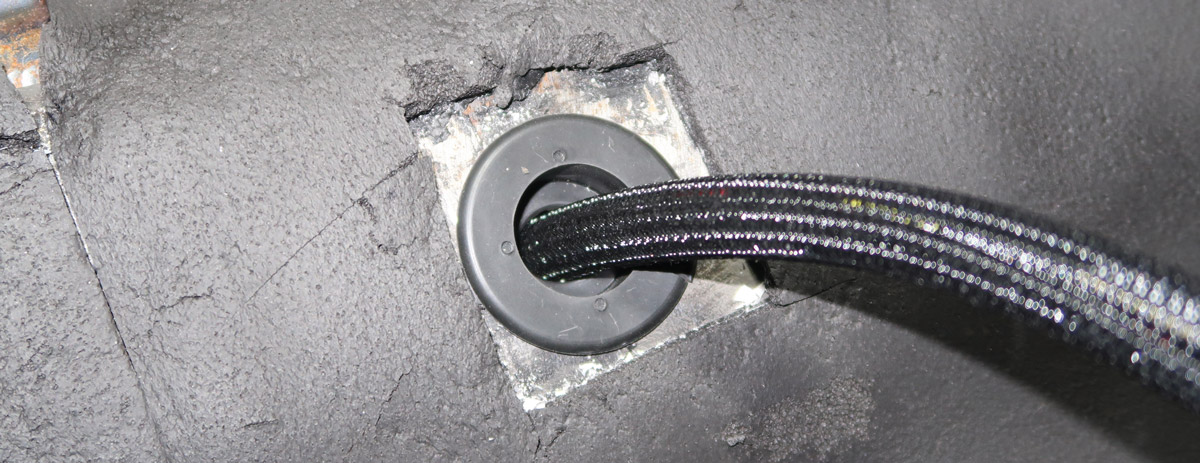 When wires pass through holes in  sheetmetal they must be protected. Rubber grommets work best and the plastic wire loom also adds protection. 