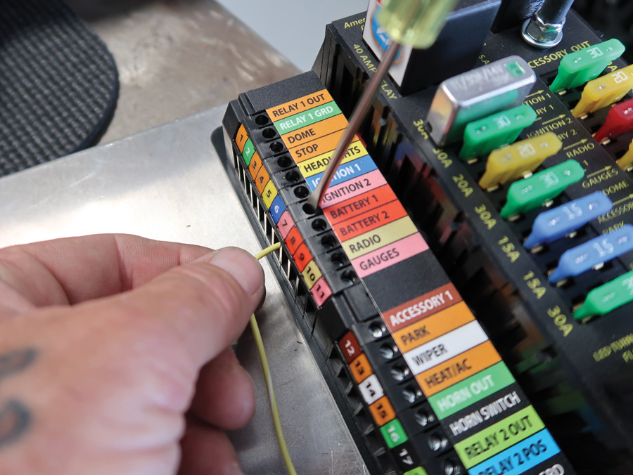 All the connection points on the Highway 22 Plus fuse block are labeled, numbered, and color-coded. To install the wires, the insulation is stripped back ³/8 inch (there is a strip gauge on the end of the fuse block for a guide). American Autowire even includes the proper screwdriver to tighten the connections.