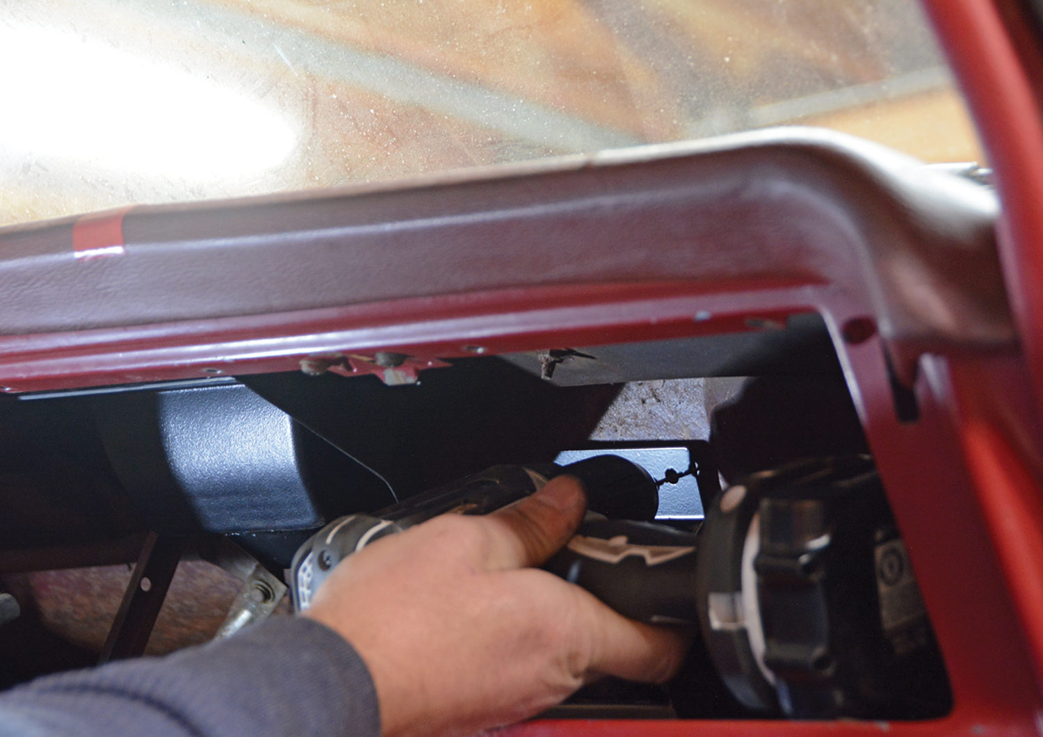 mechanic secures the upper evaporator bracket 