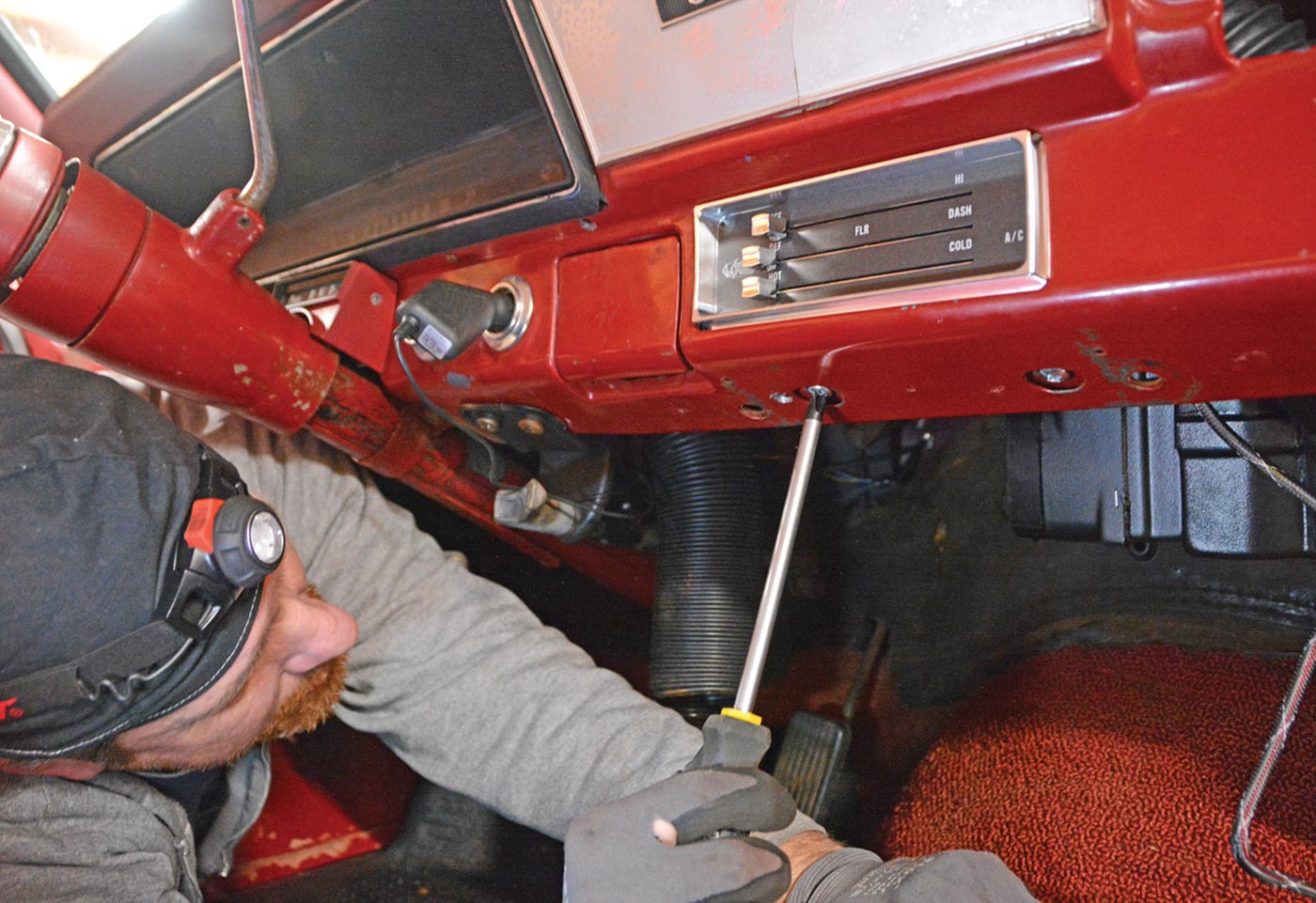 the mechanic secures the control panel in place using the original Phillips head screws