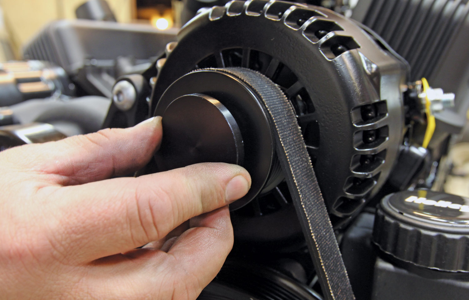 mechanic applies a cover to the A/C compressor