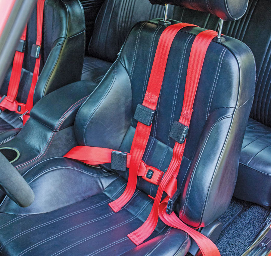 black leather seat with red seat belt