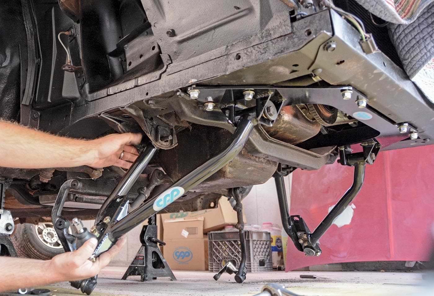 mechanic installs the lower control arms