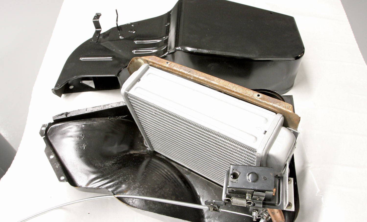 the heater core assembly is attached to the inner housing of the heater box and the water control cable is connected to the Deluxe Heater Control Valve