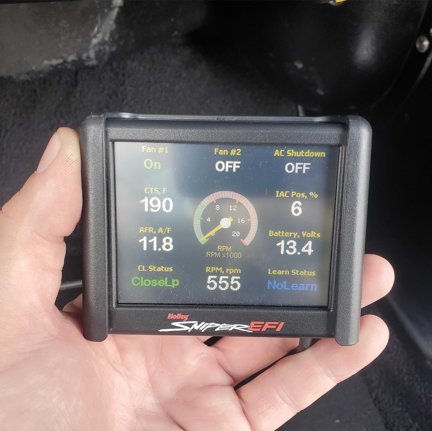 mechanic holds an included 31/2-inch touch-screen