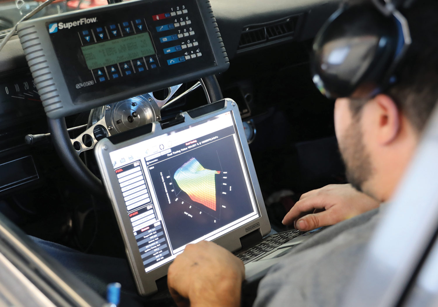 Westech’s Ishmael Candia sits in the driver seat of the Nova working with two a Superflow moniter and a laptop