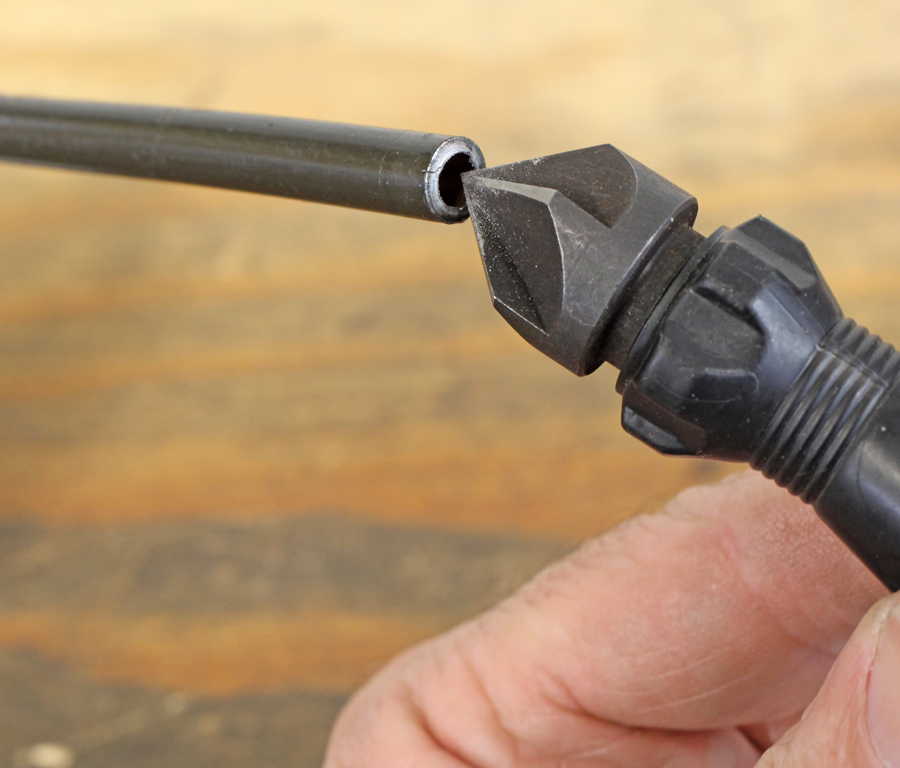 We found this reamer at Grainger that works very well at removing the burr rather than relying on that wedge-shaped device on the tubing cutter. 