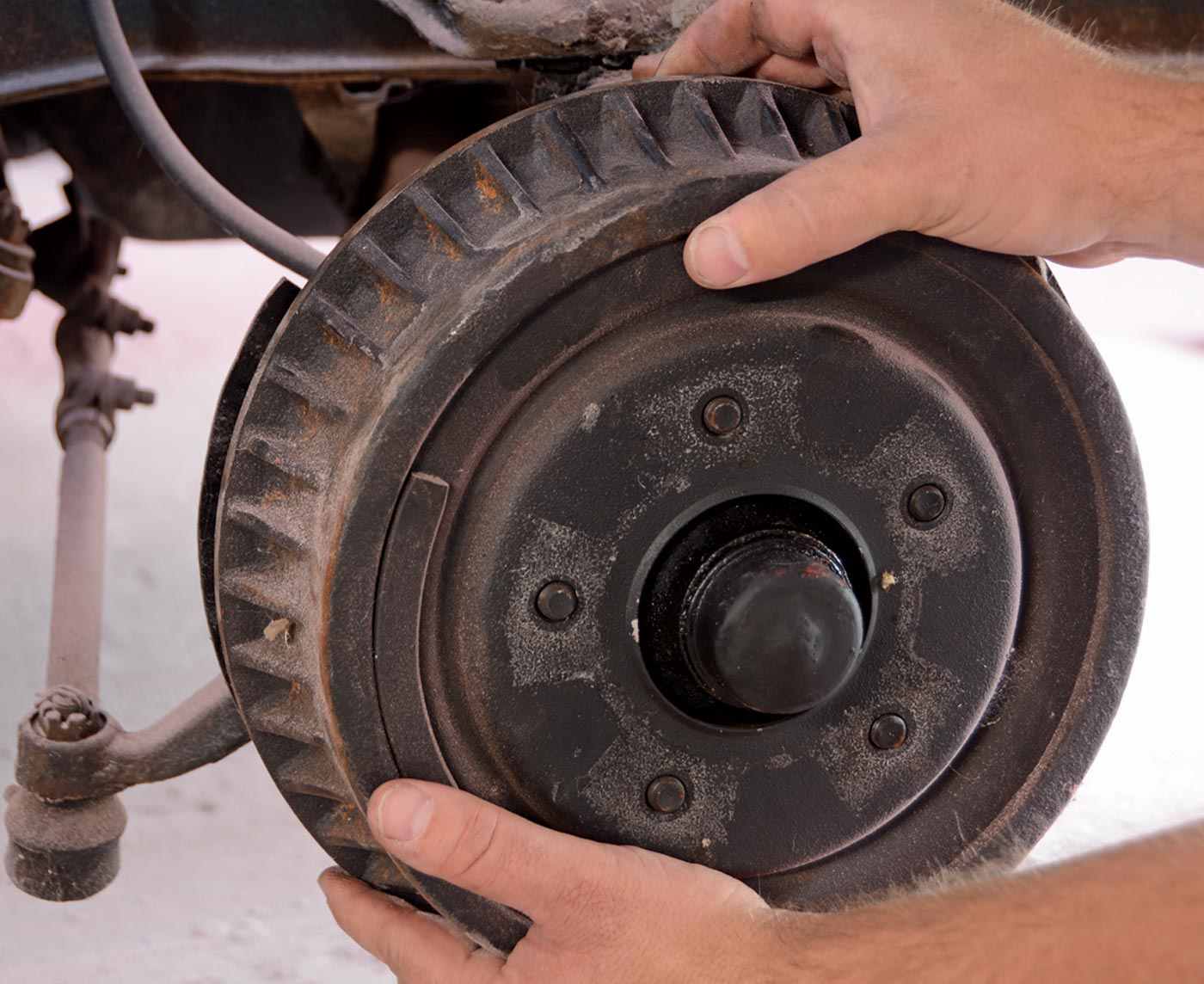 mechanic rolls a drum brake