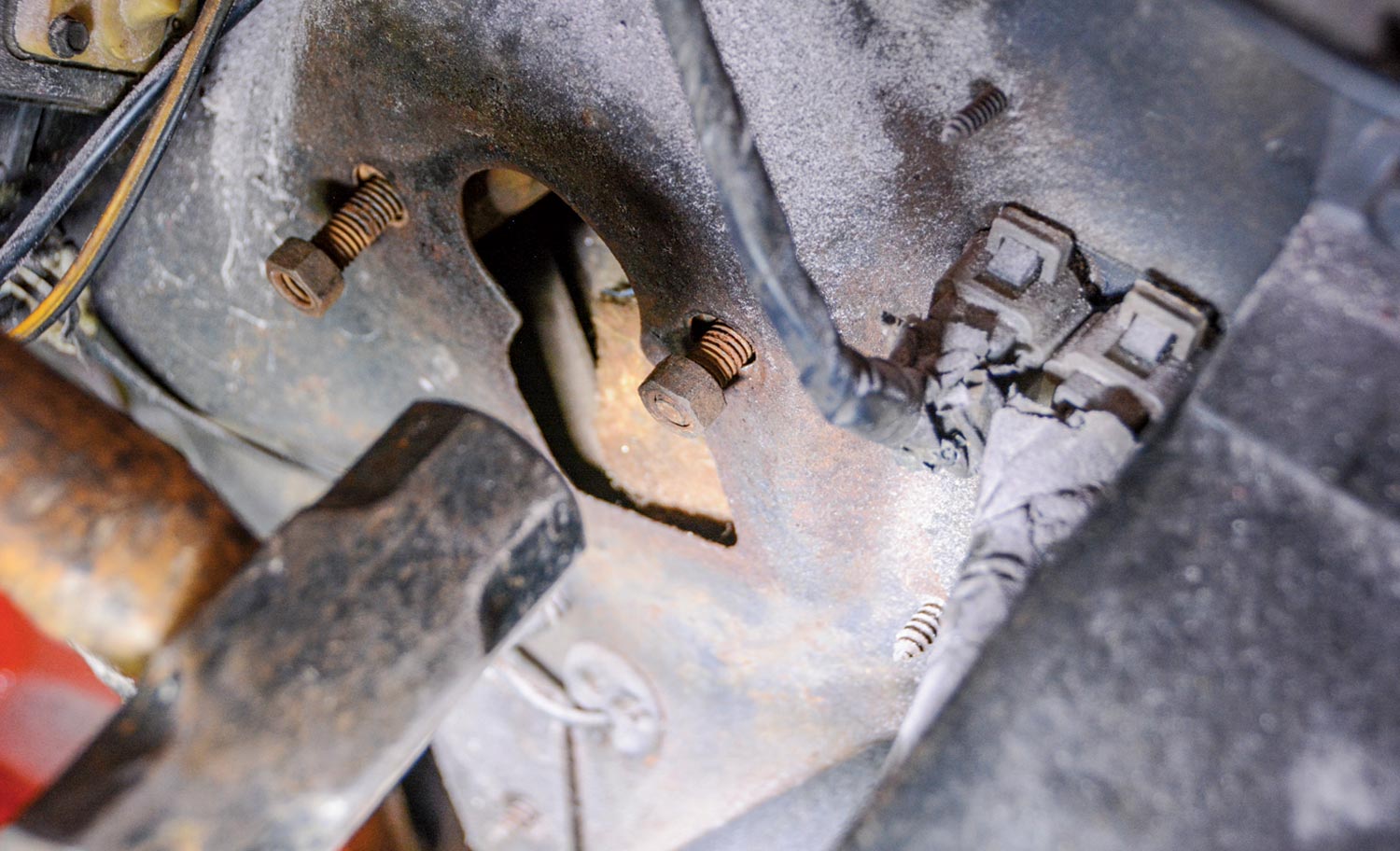 mechanic prepares to knock two studs out of the firewall