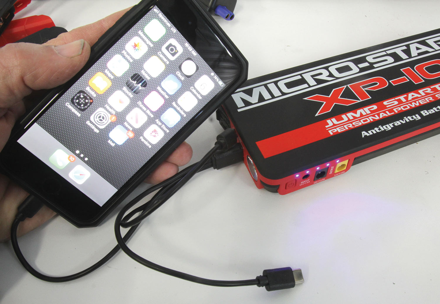 a Micro-Start unit connected to a smartphone with a USB adapter