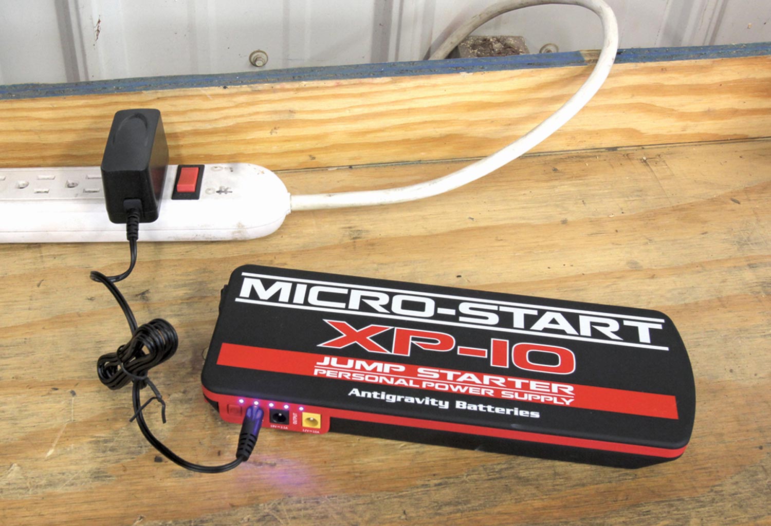 the XP-10 jump starter connected to an extended electricity outlet