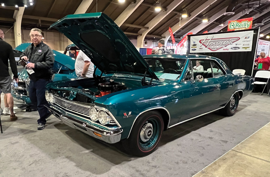 Dark cyan car with hood open