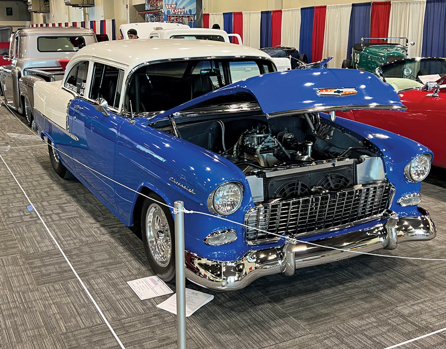 Blue and white car with its hood open