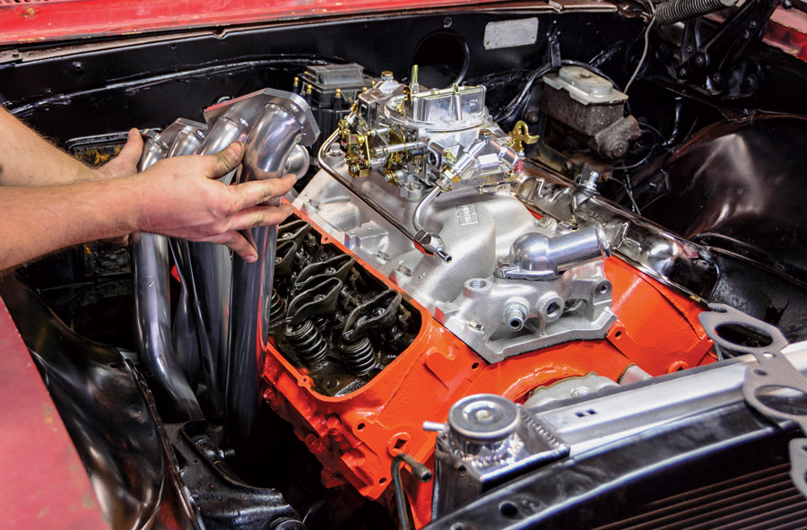  The metallic ceramic coating on these headers from Summit Racing will brighten up the engine bay and keep our big-block breathing easily. The passenger side is an easy install, but the driver side requires raising the engine to slide the header into place.