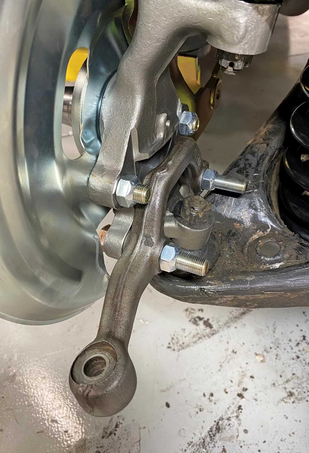 a steering arm in place, attached with Grade 8 bolts and lock nuts