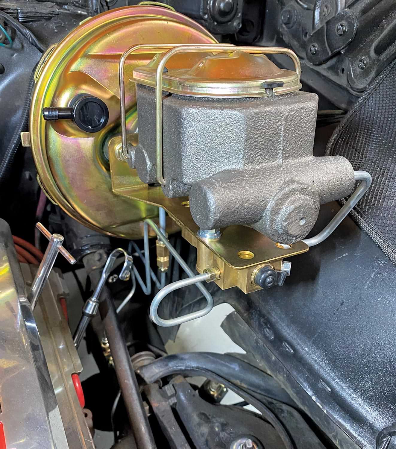 close up of POL's new disc brake master cylinder featuring an AC Delco-type proportioning valve that includes low-pressure warning light wire and plug