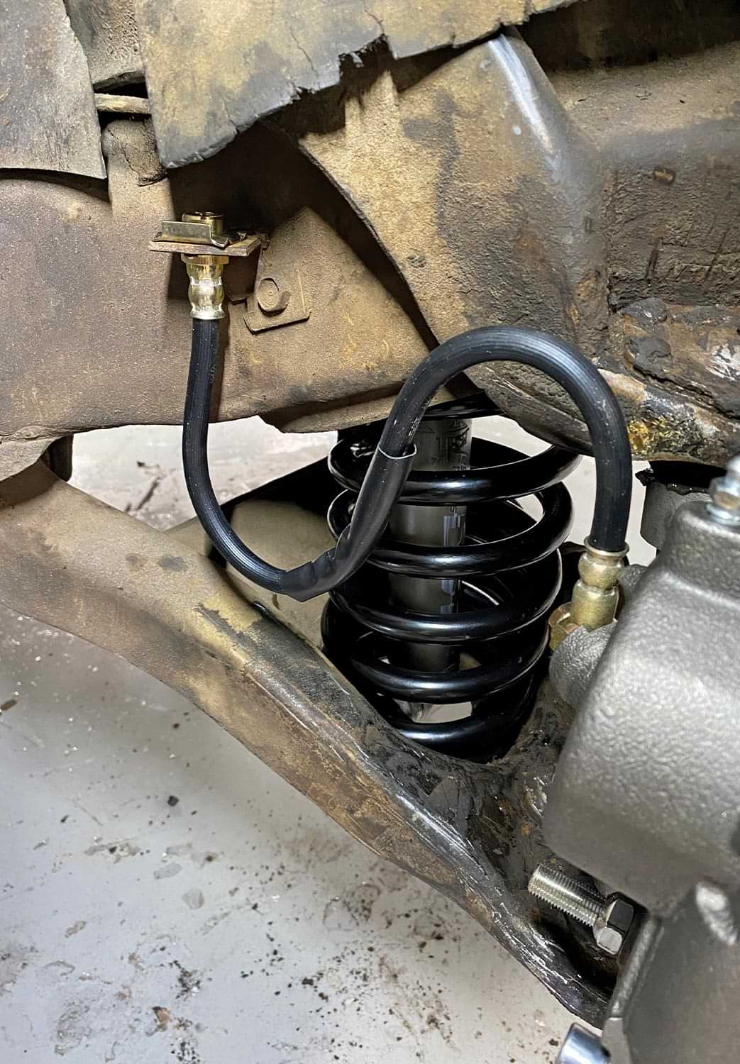 view of the newly installed rubber brake hose