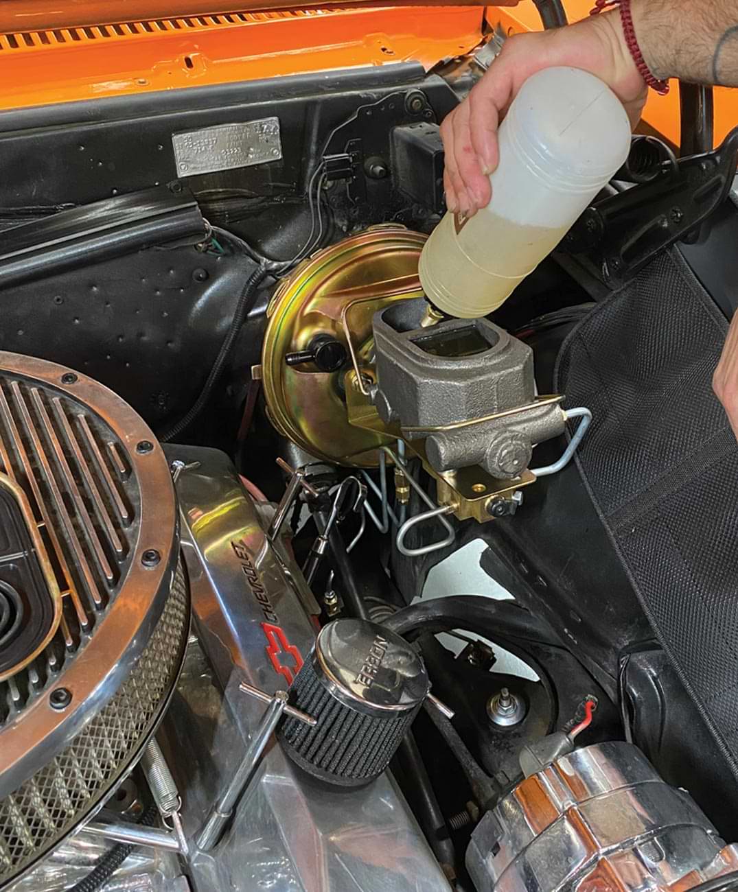 mechanic fills the master cylinder
