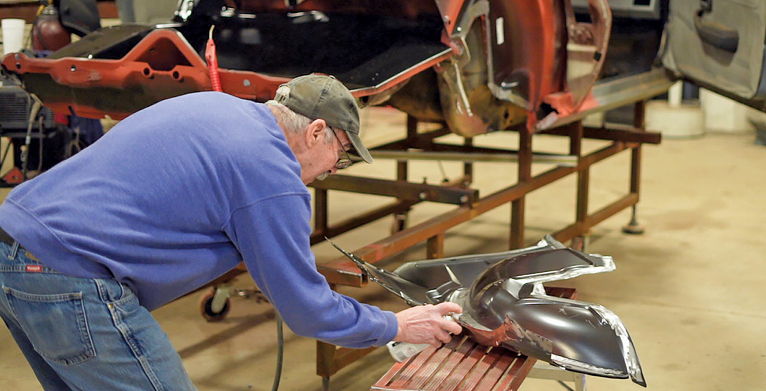 mechanic applies a coat of weld-through primer to a new inner wheelhouse