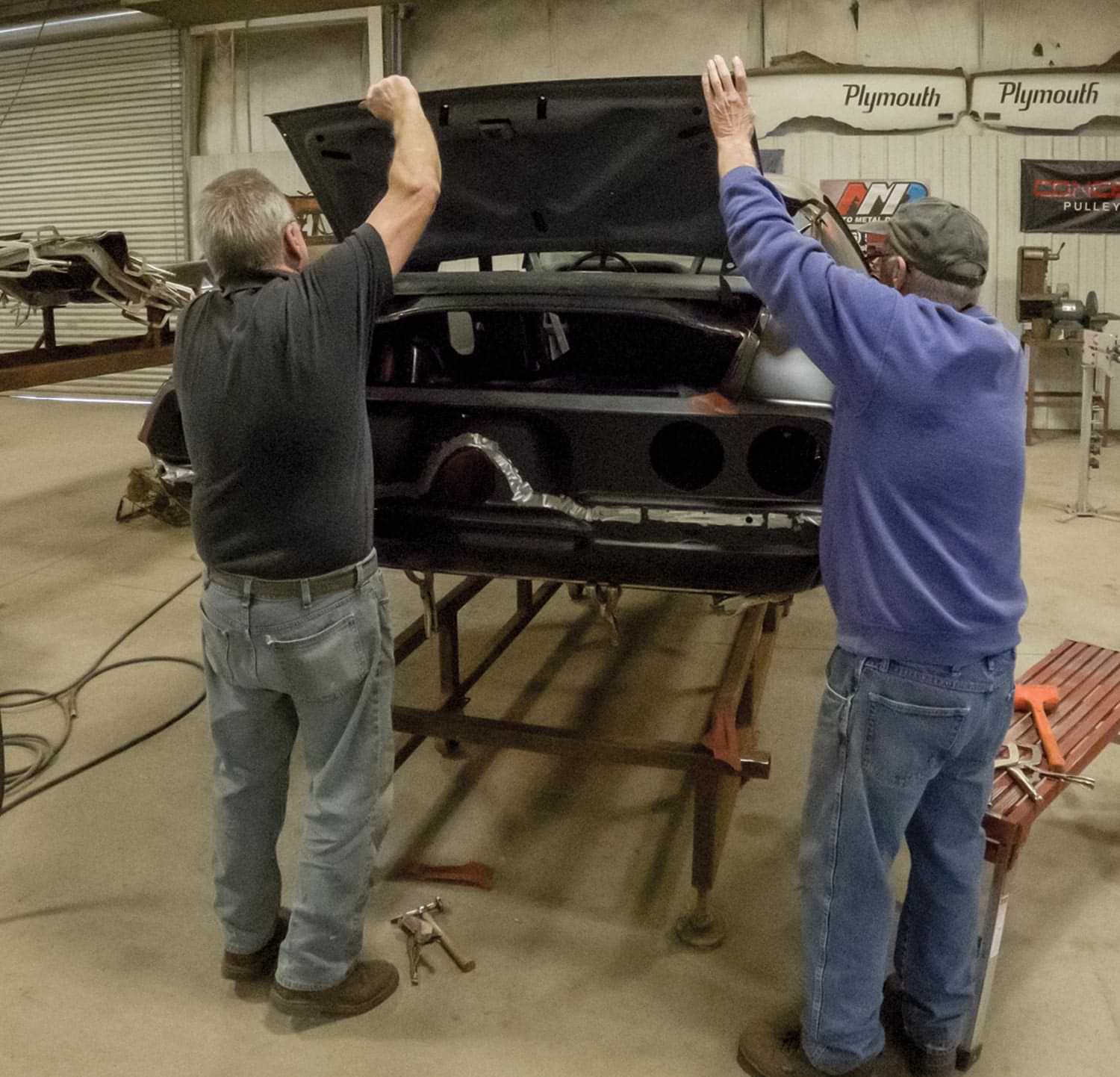 two mechanics test fit the decklid