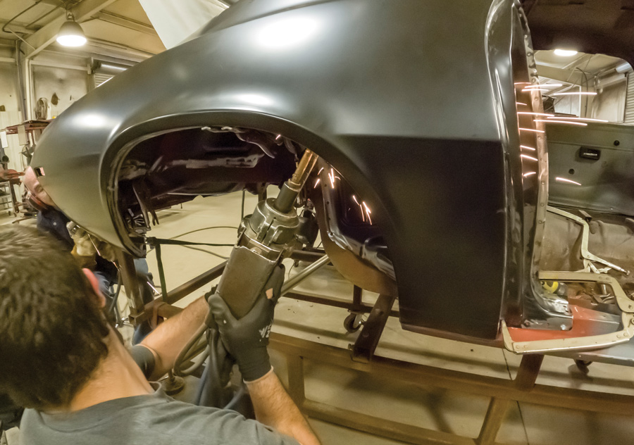 Using a spot welder, Hopkins recruits Brandon Lethiot to marry the outer wheelhouses to the quarter-panel