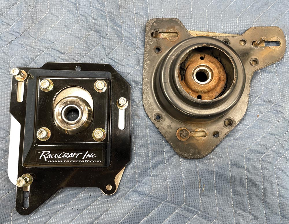 the old factory strut mount plate placed next to the new RaceCraft strut mount plate for comparison