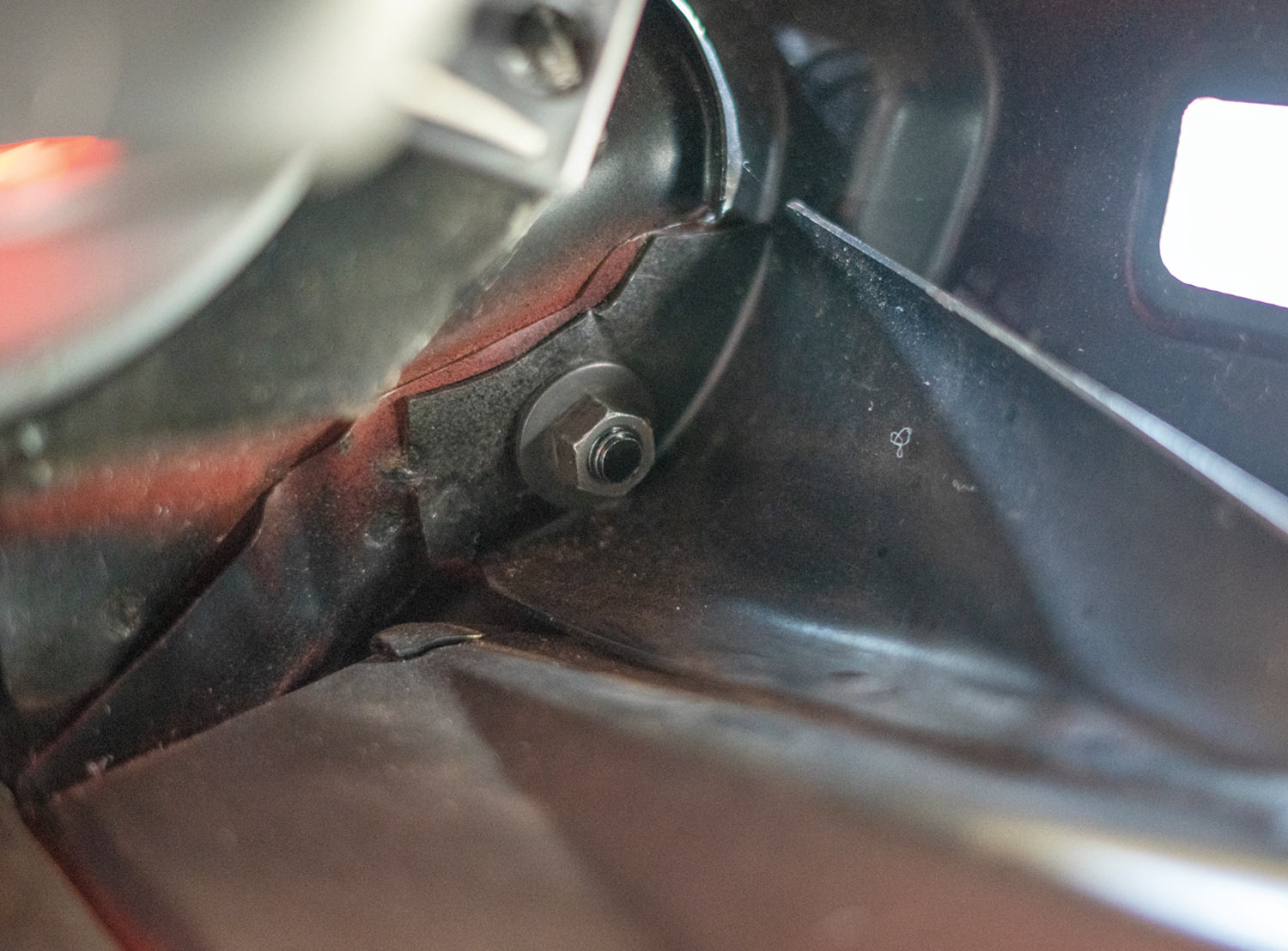close view of a bolt securing the bumper to the brackets