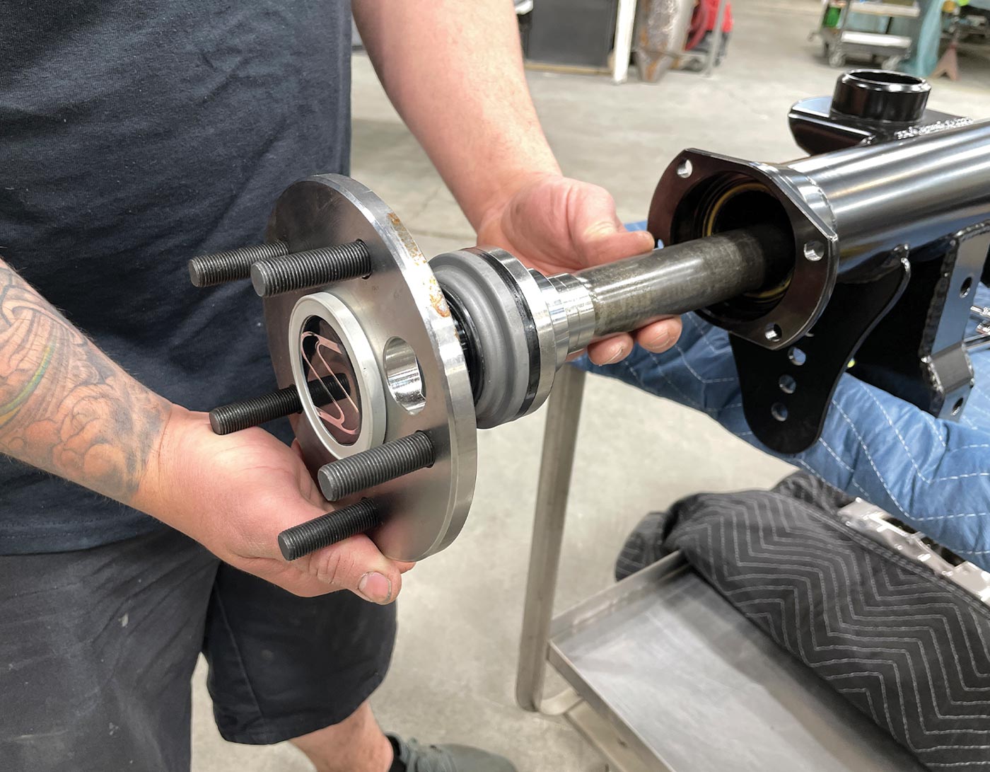 mechanic slides the new 35-spline alloy axle out from the housing