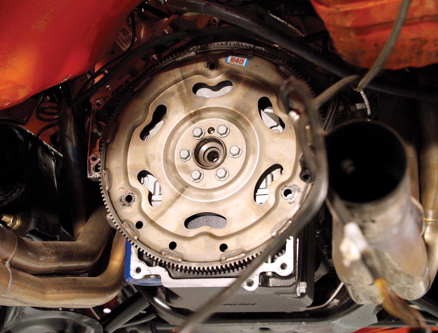 view of the transmission flexplate on the lifted Camaro