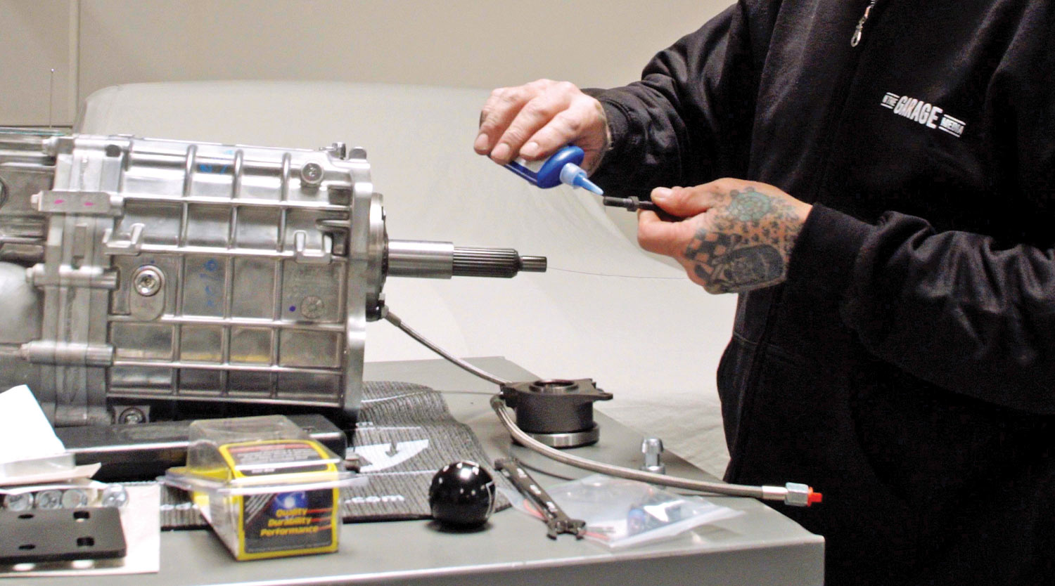 mechanic applies thread locker to a fastener to secure the installed Tilton retainer