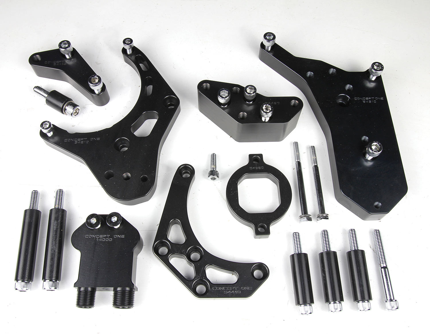 more of Concept One’s LS Victory Series Kit parts in anodized black sit on a work surface