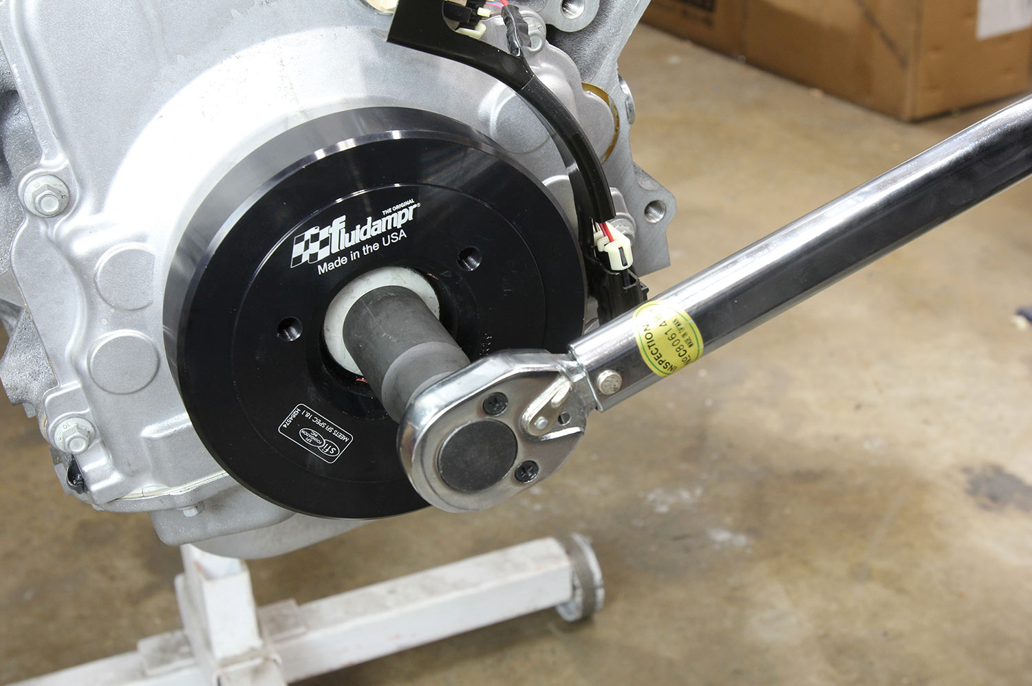 a used crankshaft bolt is installed and torqued