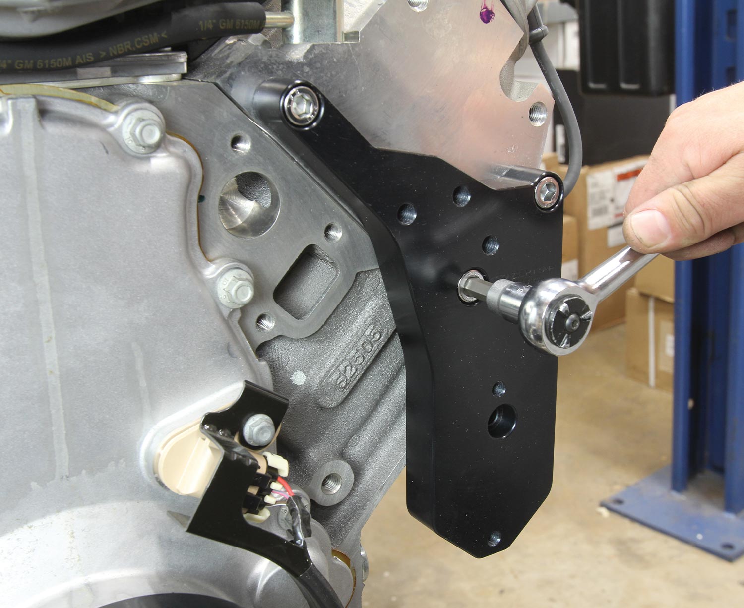 an M10 fastener is tightened on the alternator/power steering main bracket